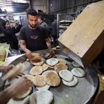 In Gaza, limited food aid meets desperate crowds and looting